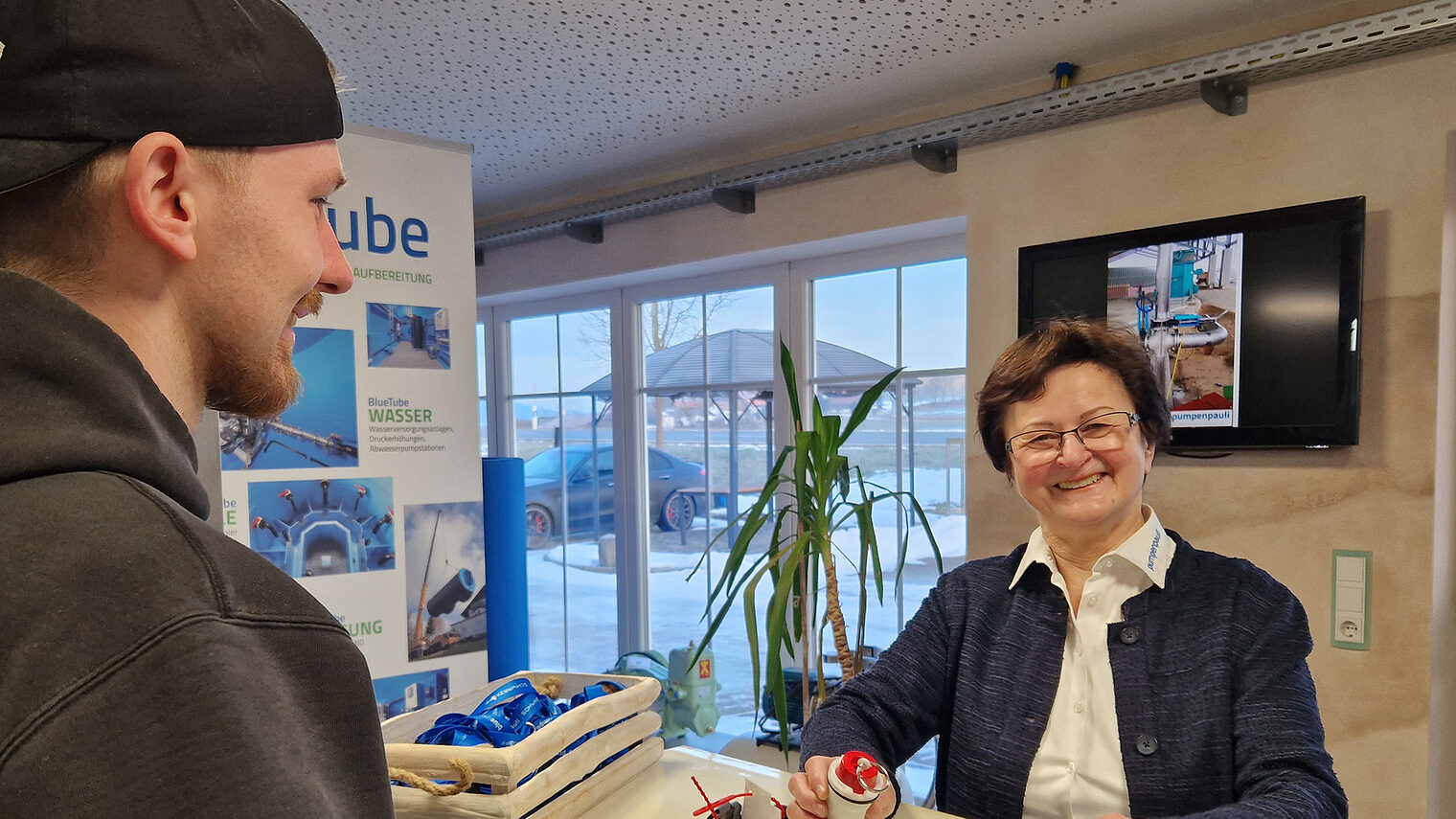 Gunda Pauli im Gespräch mit einem Mitarbeiter im Eingangsbereich ihrer Fima. 
