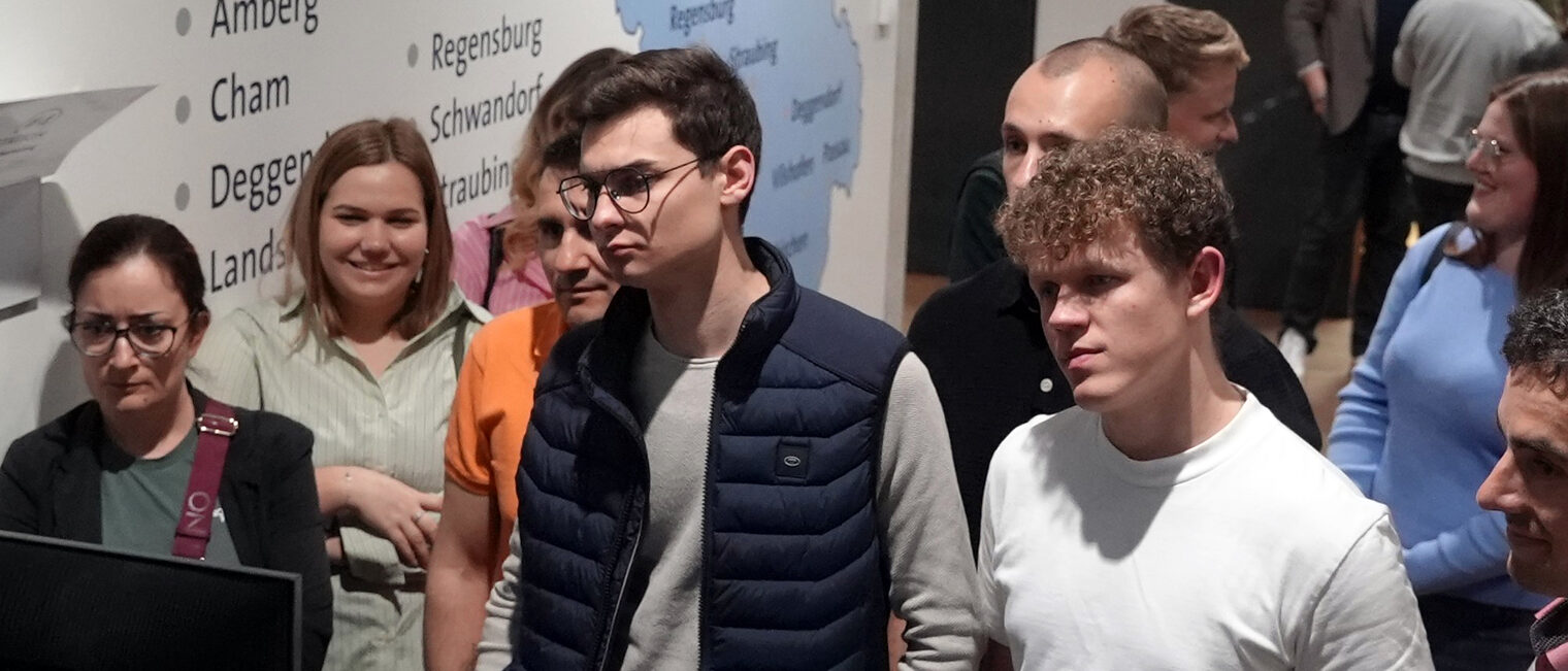 Den Betriebswirten wurden viele Beispiele zur KI-Anwendung vorgestellt. Sie sehen gespannt zu. 